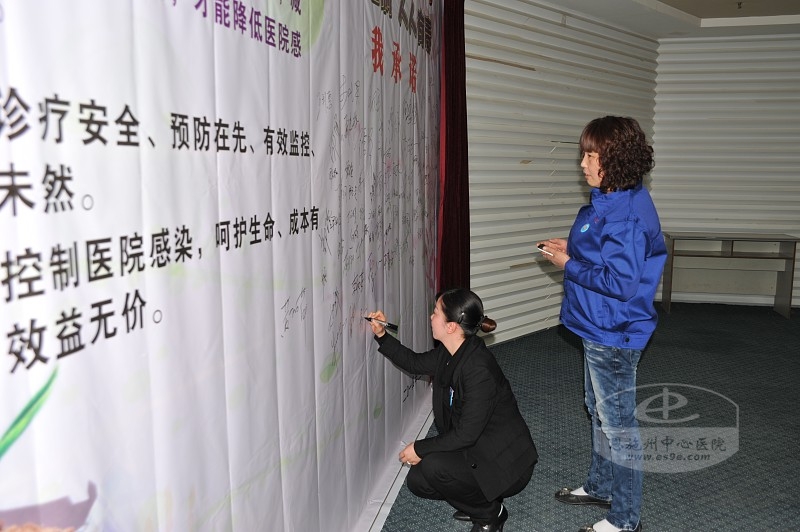 物业公司员工在签名承诺墙上签字